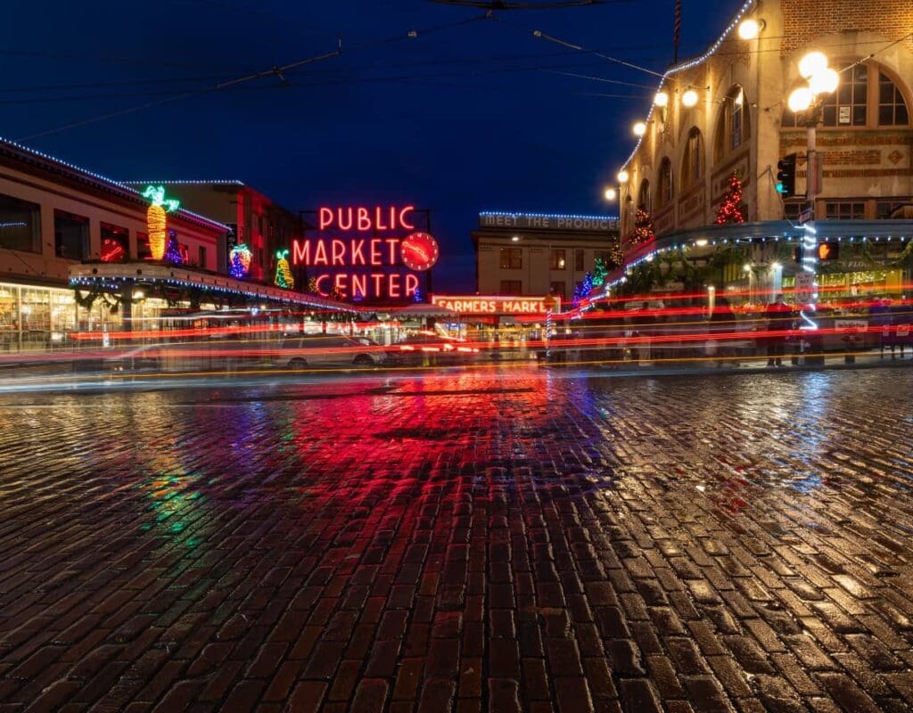 a photo of pike place market at night with holiday lights